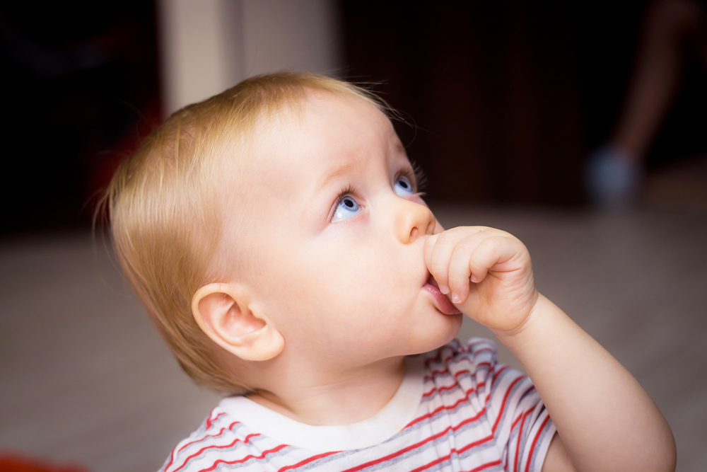 Child at dental appointment to assess thumb sucking impact on teeth